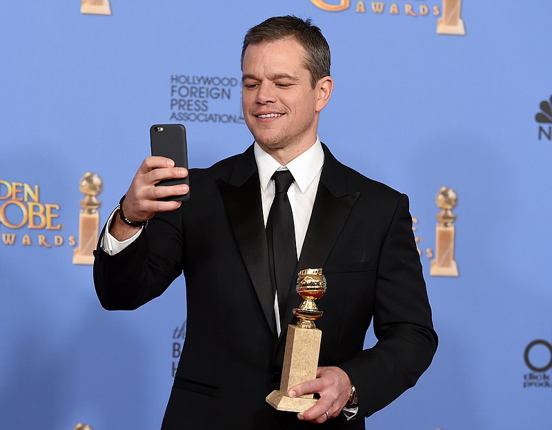 Matt Damon poses in the press room with the award for best performance by an actor in a motion picture - musical or comedy for "The Martian" at the 73rd annual Golden Globe Awards on Sunday, Jan. 10, 2016, at the Beverly Hilton Hotel in Beverly Hills, Calif. (Photo by Jordan Strauss/Invision/AP)