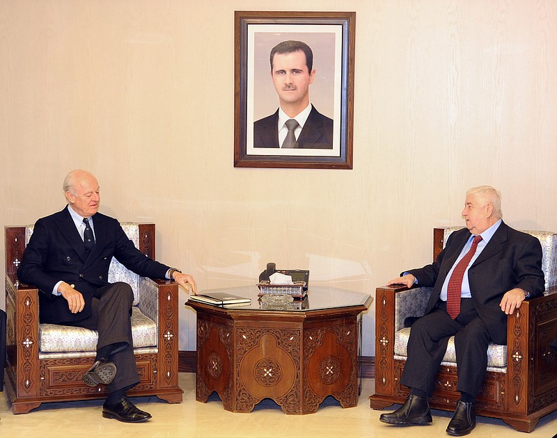 
              In this photo released by the Syrian official news agency SANA, Syria's Foreign Minister Walid al-Moallem, second right, meets with U.N. Special Envoy for Syria Staffan de Mistura, second left, in Damascus, Syria, Saturday, Jan. 9, 2016. Syria is ready to attend peace talks later this month in Geneva but the government wants to see lists of the opposition groups who will attend and ensure that "terrorist" groups that will not, the country's foreign minister said Saturday according to SANA. (SANA via AP)
            