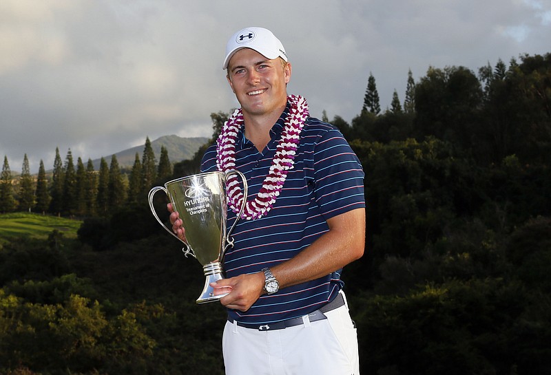 
              Jordan Spieth poses for photographers as he holds the trophy after his win in the Tournament of Champions golf event Sunday, Jan. 10, 2016, at Kapalua Plantation Course in Kapalua, Hawaii. Spieth finished with at 30 under par for the tourney. (AP Photo/Matt York)
            