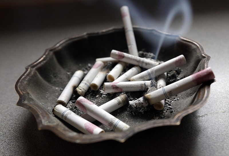 
              FILE - In this Saturday, March 2, 2013, photo, a cigarette burns in an ashtray at a home in Hayneville, Ala. A government study released on Monday, Jan. 11, 2016, shows that even though fewer U.S. teens are smoking, exposure to secondhand smoke remains a big problem. Nearly half of nonsmoking kids in middle school and high school were exposed to secondhand tobacco smoke in 2013, and rates were even higher among smokers. (AP Photo/Dave Martin)
            