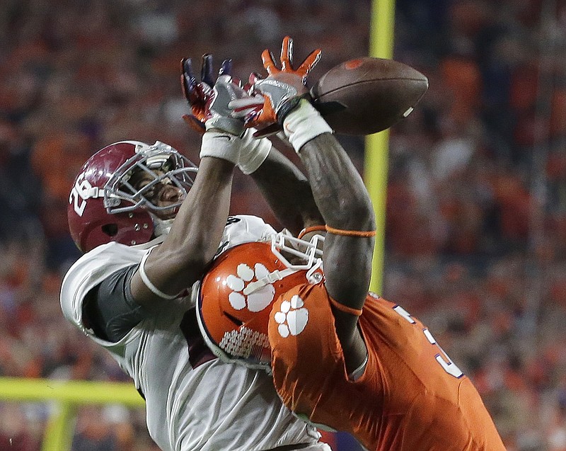 Alabama's Marlon Humphrey, left, breaks up a pass intended for Clemson's Artavis Scott during the second half of the NCAA college football playoff championship game Monday, Jan. 11, 2016, in Glendale, Ariz.
