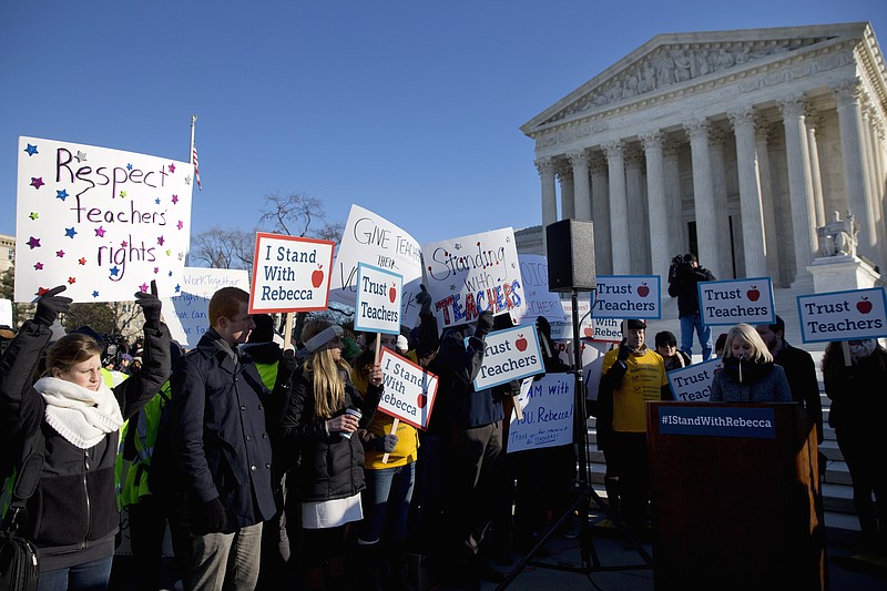 People participate in a rally at the Supreme Court in Washington, D.C., Monday as oral arguments were heard in Friedrichs v. California Teachers Association, which is challenging the right of public-employee unions to collect fees from state and local government workers who choose not to become members.