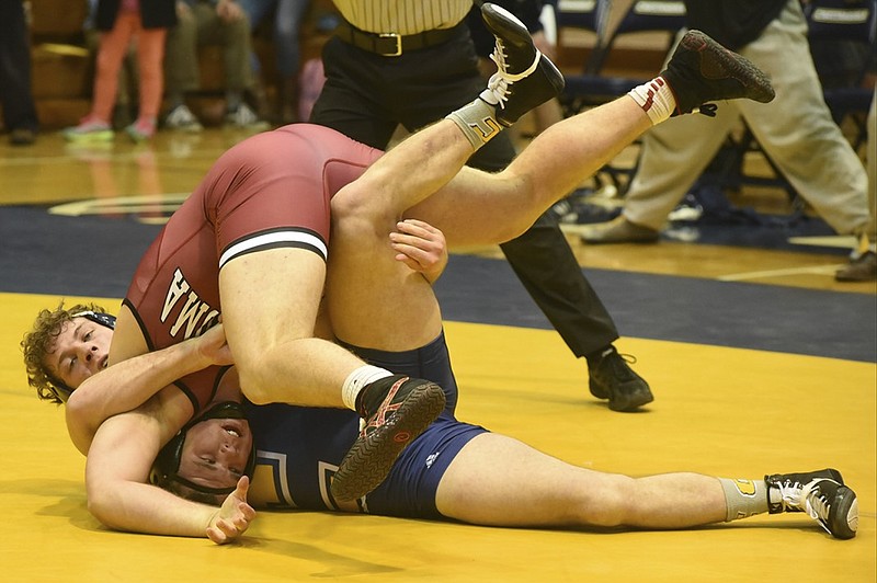 University of Tennessee at Chattanooga 285-pound-class wrestler Jared Johnson, left, controls Ross Larson of Oklahoma on the way to a 12-11 win in the final match of the day as the UTC team comes from behind to defeat Oklahoma by a team score of 19-16 on Sunday, Feb. 15, 2015, in Chattanooga, Tenn.