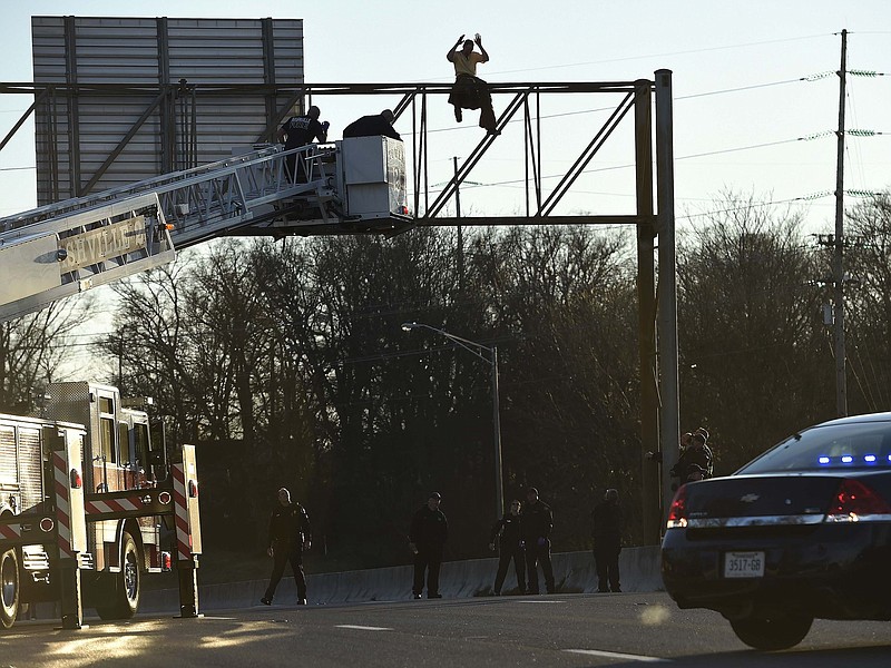 A man who climbed atop a road sign along a major Nashville highway and stayed there for two hours, bringing traffic to a halt as he dangled his feet, has been sentenced to 20 days in jail.
