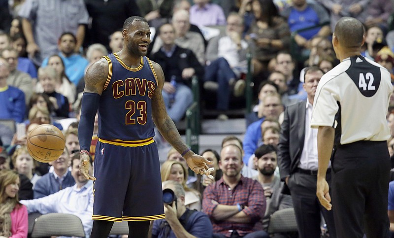 
              Cleveland Cavaliers forward LeBron James (23) questions a call by referee Eric Lewis (42) during the first half of an NBA basketball game against the Dallas Mavericks, Tuesday, Jan. 12, 2016, in Dallas. (AP Photo/LM Otero)
            