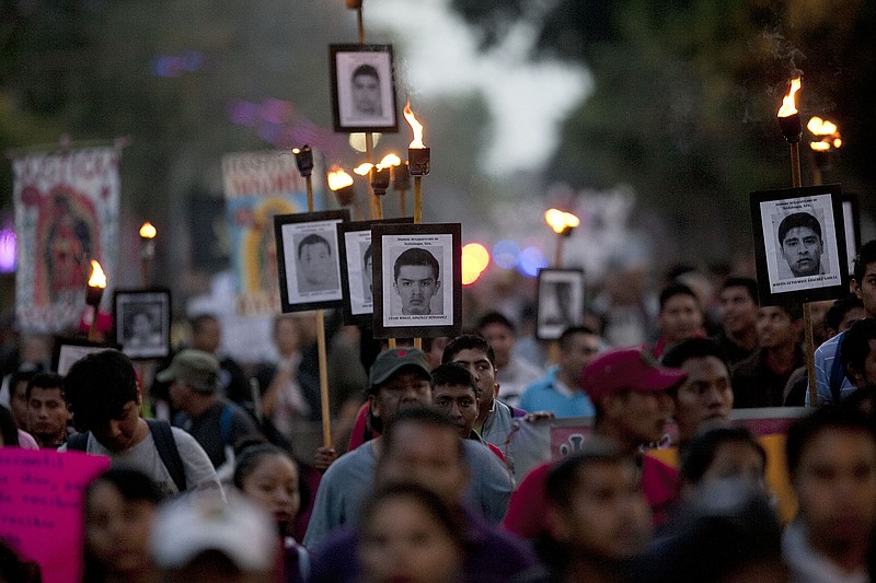 
              FILE - In this Dec. 26, 2015, file photo, relatives of the 43 missing students from the Isidro Burgos rural teachers college march holding pictures of their missing loved ones during a protest in Mexico City. An appeals court ruling is threatening to derail Mexico’s effort to prosecute suspects in one of its most notorious crimes of recent years: the disappearance and presumed murder of the 43 students in Guerrero state. (AP Photo/Marco Ugarte, File)
            