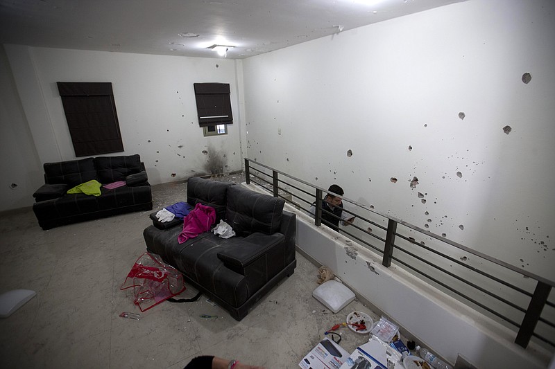 Bullet holes riddle the walls of the second floor of the home that marines raided in their search for Mexican drug lord Joaquin "El Chapo" Guzman in Los Mochis, Mexico, Monday, Jan. 11, 2016.