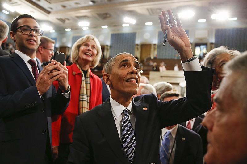 
              President Barack Obama waves as he walks back up the aisle at conclusion of his State of the Union address to a joint session of Congress on Capitol Hill in Washington, Tuesday, Jan. 12, 2016. (AP Photo/Evan Vucci, Pool)
            