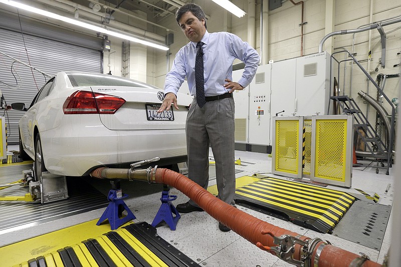 
              FILE - In this Sept. 30, 2015, file photo, John Swanton, spokesman with the California Air Resources Board, explains how a 2013 Volkswagen Passat with a diesel engine is evaluated at the emissions test lab in El Monte, Calif. California air quality regulators, on Tuesday, Jan. 12, 2016, rejected Volkswagen's recall plan to fix vehicles including the Beetle and Jetta that were programmed to trick government emissions tests. (AP Photo/Nick Ut,File)
            