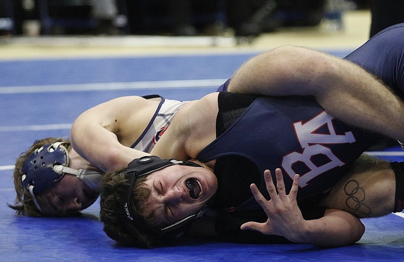Heritage's Charles Thurman, left, tries to pin Brentwood Academy's Justin Becci during a 120-pound match at last season's McCallie Invitational. Heritage will be among 16 teams competing for the Class AAAA title today when the GHSA's state duals begin at the Centreplex in Macon.