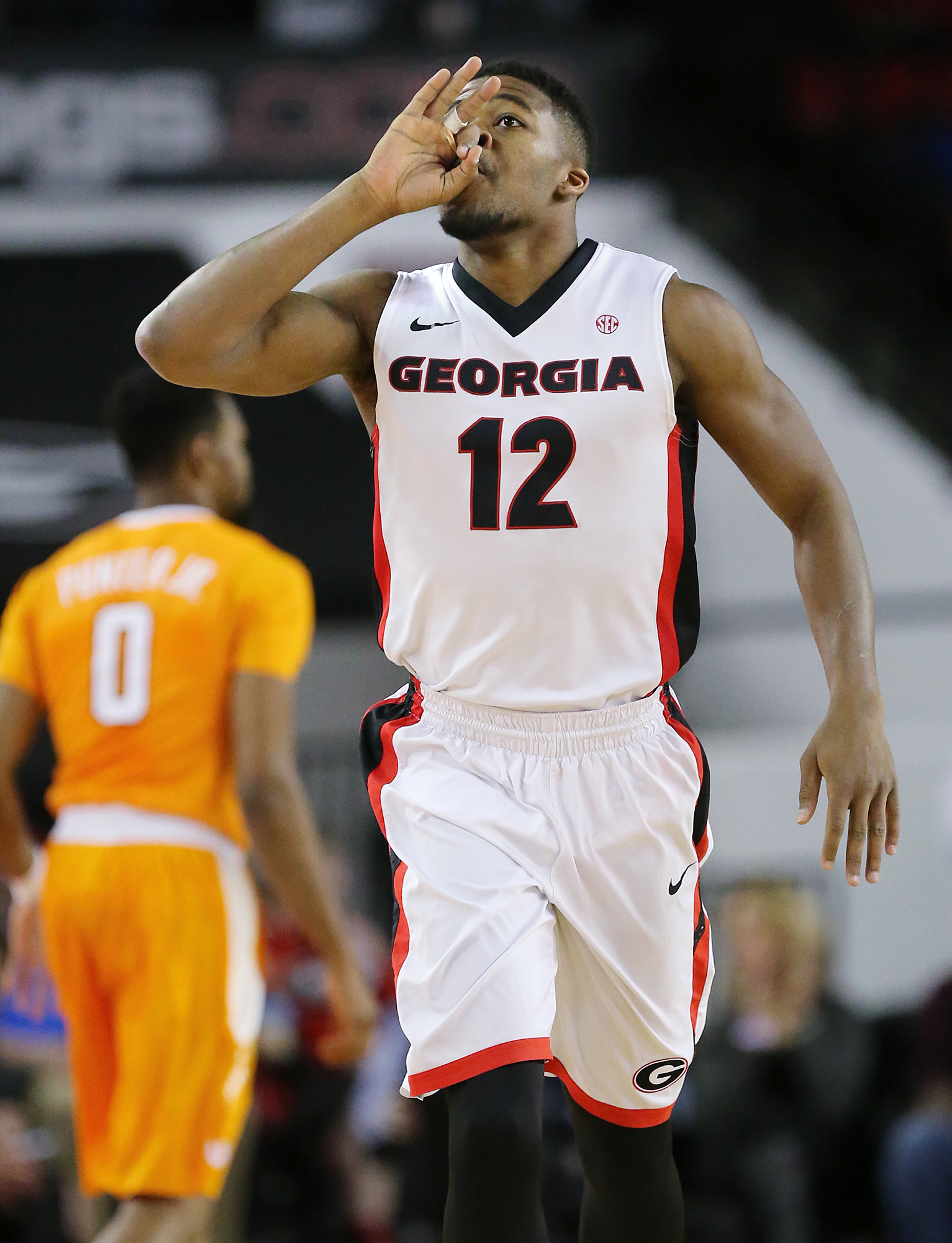 Georgia guard Kenny Gaines reacts to hitting a 3-pointer against Tennessee guard Kevin Punter during an NCAA college basketball game Wednesday, Jan. 13, 2016, in Athens, Ga. (Curtis Compton/Atlanta Journal Constitution via AP)