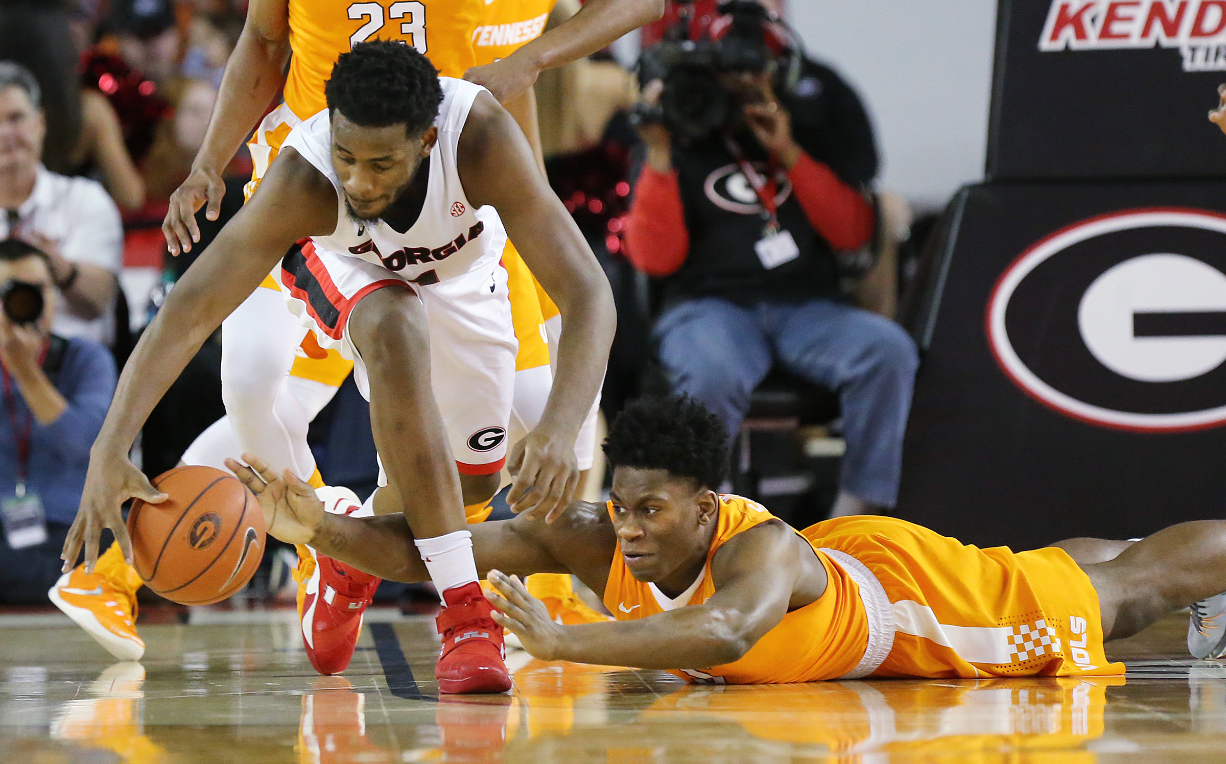 Georgia guard William Jackson II and Tennessee forward Admiral Schofield reach for the ball during the first half of an NCAA college basketball game Wednesday, Jan. 13, 2016, in Athens, Ga. (Curtis Compton/Atlanta Journal Constitution via AP)