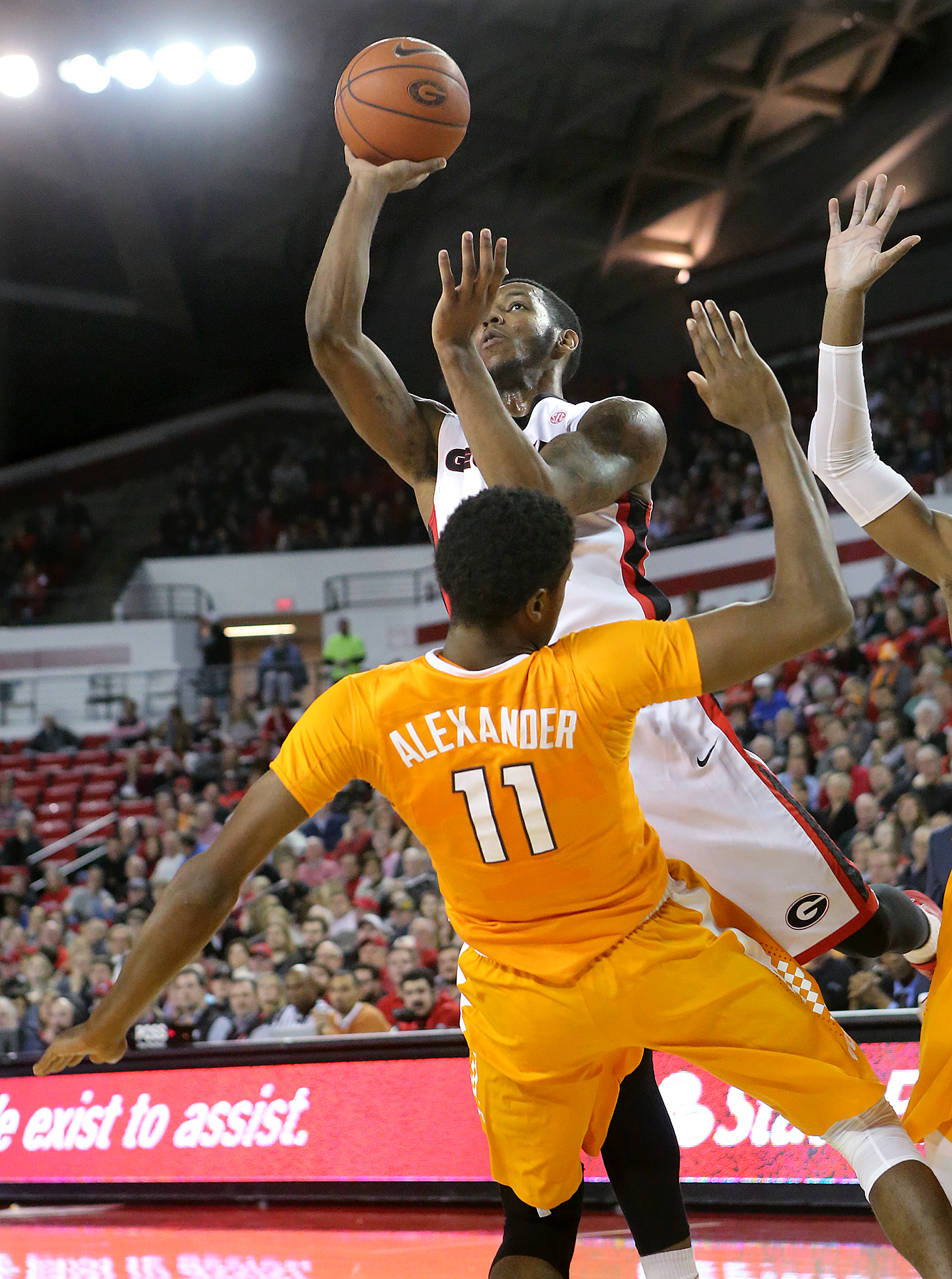 Georgia guard Charles Mann knocks Tennessee forward Kyle Alexander to the hardwood for an offensive foul during an NCAA college basketball game Wednesday, Jan. 13, 2016, in Athens, Ga. (Curtis Compton/Atlanta Journal Constitution via AP)
