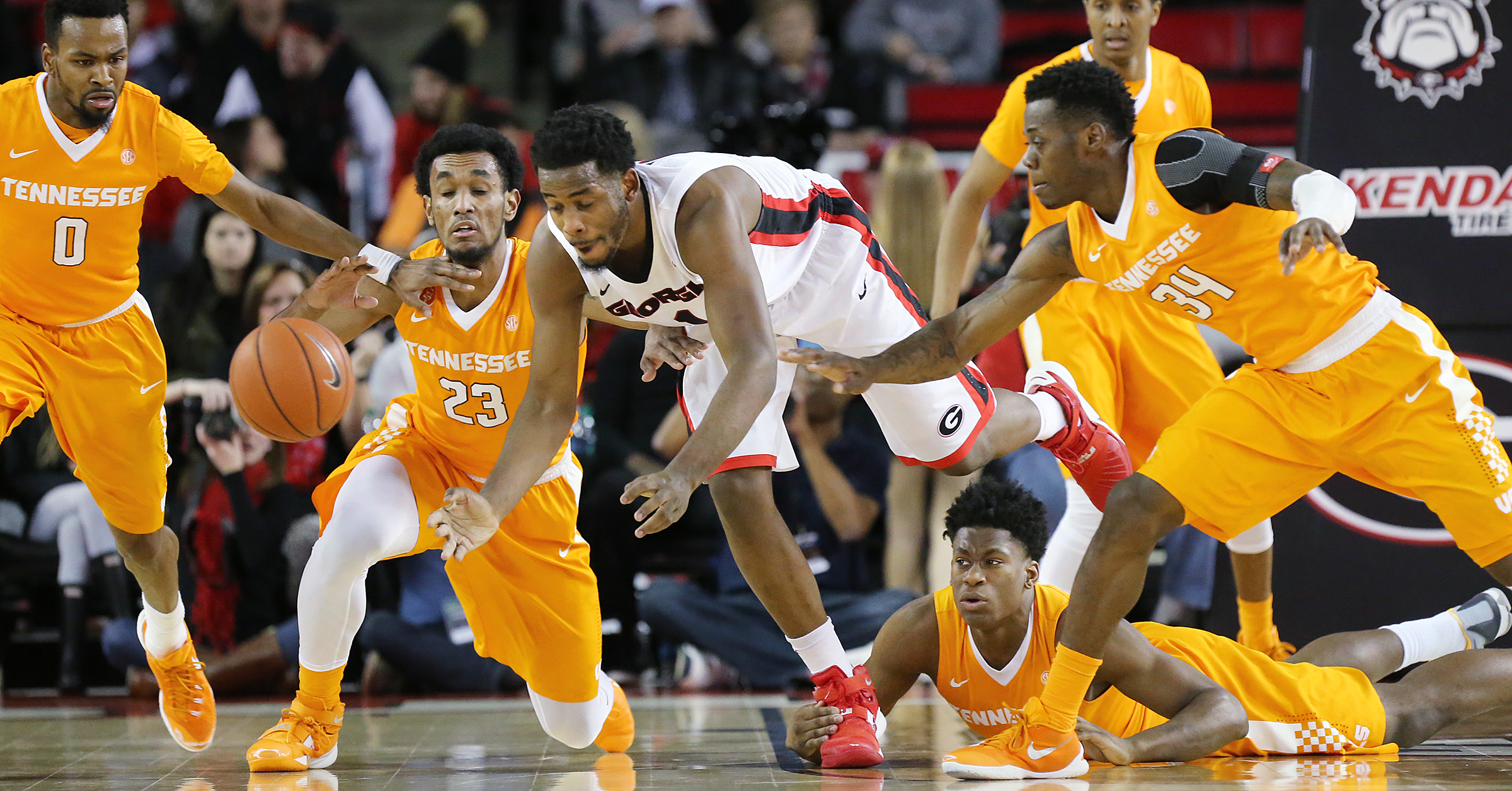 Tennessee defenders Kevin Punter, Derek Reese, Admiral Schofield, and Devon Baulkman, from left, team up to steal the ball from Georgia forward Yante Maten during the first half of an NCAA college basketball game Wednesday, Jan. 13, 2016, in Athens, Ga. (Curtis Compton/Atlanta Journal Constitution via AP)