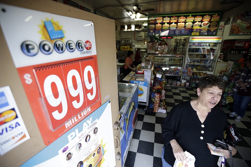 Annette Spadafore leaves a store with her lottery ticket Wednesday, Jan. 13, 2016, in San Diego. With a Powerball jackpot for Wednesday night's drawing at an estimated $1.5 billion, many flocked to pick up a ticket in hopes of winning what could be the largest lottery jackpot in the world. (AP Photo/Gregory Bull)