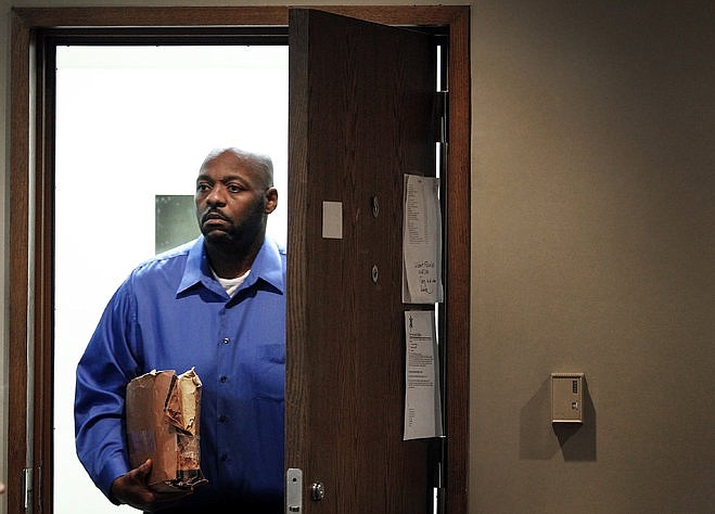 Defendant Errol Johnson (left) enters the courtroom before his trial for first-degree murder in perpetration of aggravated child neglect, in the death of his 12 year-old daughter, Andrea Ruth, in Judge Bobby Carter's Division 3 courtroom Tuesday afternoon.
