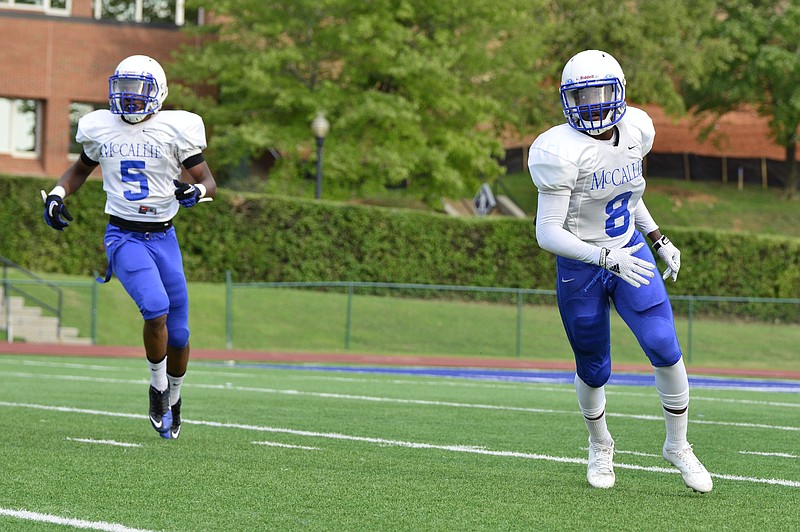 Defensive backs J.J. Lewis, left and Nygel Edmonds watch as a teammate intercepts the ball during a scrimmage game against Sevier County at McCallie High School  in Chattanooga, Tenn. on July 31, 2014.