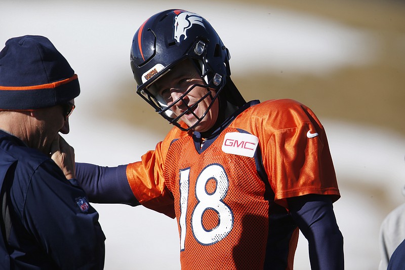 Denver Broncos quarterback Peyton Manning, right, confers with quarterback coach Greg Knapp during an NFL football practice Thursday, Jan. 14, 2016, in Englewood, Colo. The Broncos are preparing for their divisional round AFC playoff game against the Pittsburgh Steelers Sunday in Denver. (AP Photo/David Zalubowski)