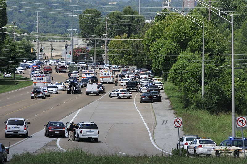 Dozens of police and emergency vehicles crowd Amnicola Highway after a morning shooting at the Naval and Marine Reserve Center at the Chattanooga Riverpark.
The Reserve Recruitment Center at Hwy 153 and Lee Hwy is cordoned off with blue shell casing markers in the parking lot. 