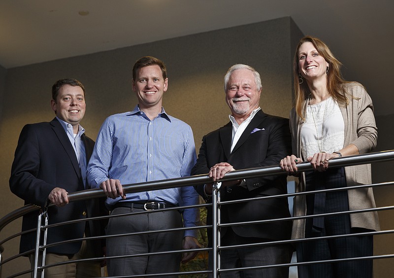 U.S. Xpress's Eric Peterson, Eric Fuller, Max Fuller, and Lisa Pate, from left, pose for a portrait in their offices Tuesday, Dec. 8, 2015, in Chattanooga, Tenn.