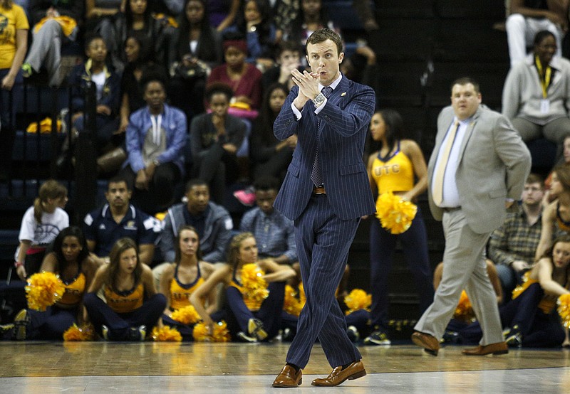 UTC head coach Matt McCall shouts as he goes onto the court for a timeout during the Mocs' home basketball game against ETSU at McKenzie Arena on Saturday, Jan. 16, 2016, in Chattanooga, Tenn.