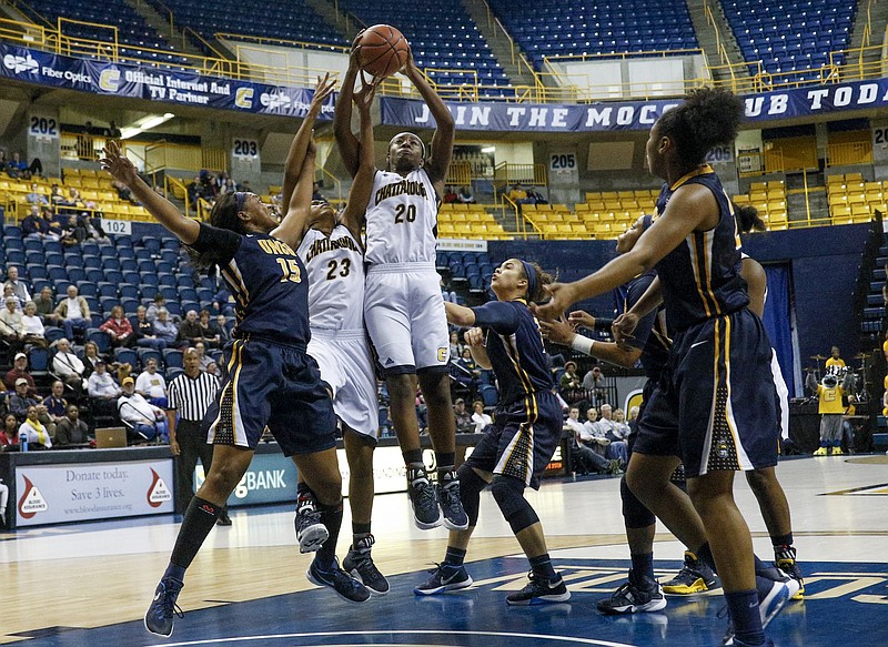UTC guard Keiana Gilbert (20) rebounds the ball with teammate Moses Johnson (23) against UNCG forward Jade Scaife (15) during the Mocs' home basketball game against UNC-Greensboro at McKenzie Arena on Saturday, Jan. 16, 2016, in Chattanooga, Tenn.