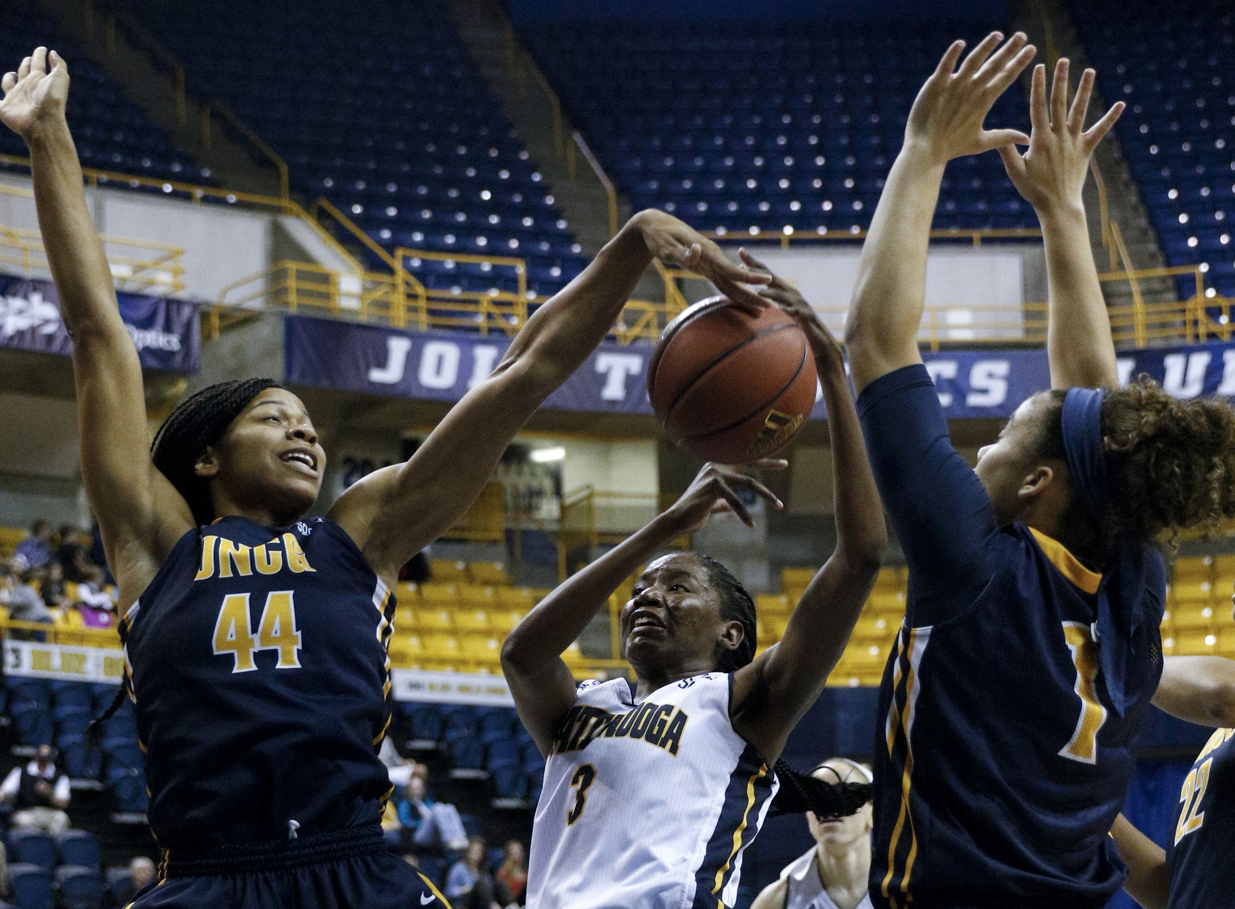 UNCG center Mariah Wilson (44) tips the ball away from UTC forward Jasmine Joyner (3) during the Mocs' home basketball game against UNC-Greensboro at McKenzie Arena on Saturday, Jan. 16, 2016, in Chattanooga, Tenn.