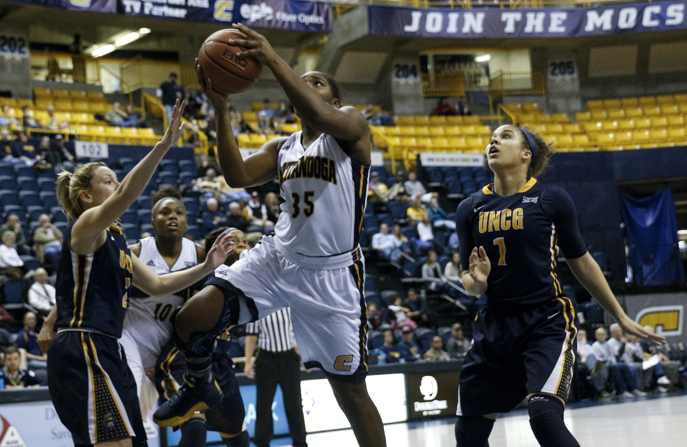 UTC guard Aryanna Gilbert (35) shoots between UNCG guards Kaitlin Callahan, left, and Keli Foster during the Mocs' home basketball game against UNC-Greensboro at McKenzie Arena on Saturday, Jan. 16, 2016, in Chattanooga, Tenn.