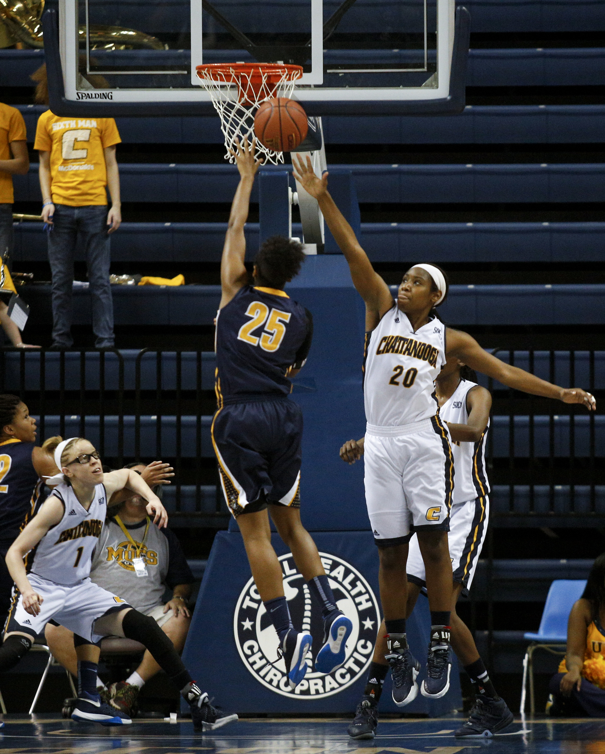 UTC guard Keiana Gilbert (20) tries to block a shot by UNCG guard Shanese Harris during the Mocs' home basketball game against UNC-Greensboro at McKenzie Arena on Saturday, Jan. 16, 2016, in Chattanooga, Tenn.