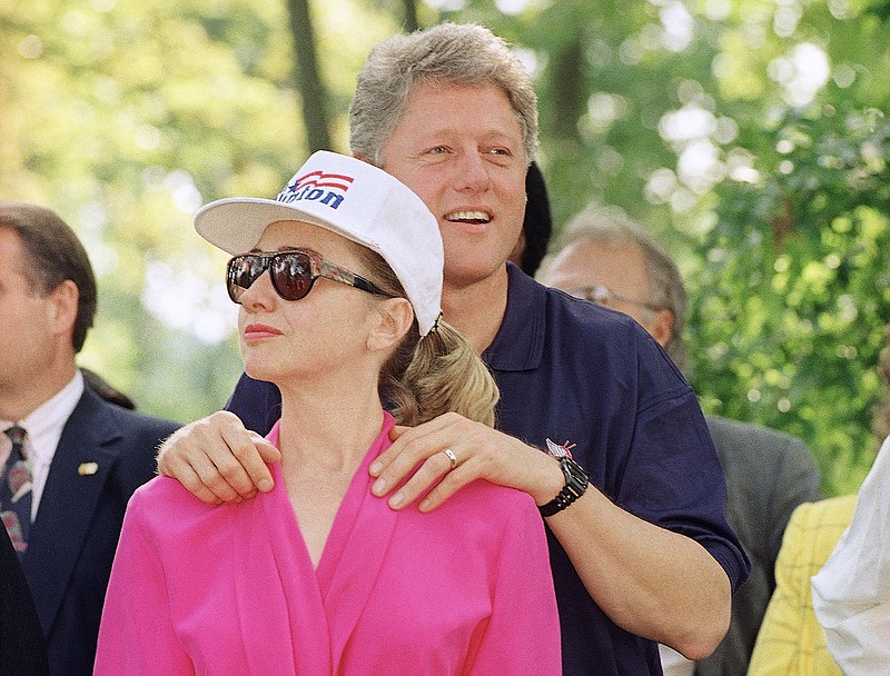 
              FILE - In this July 21, 1992 file photo, then-Democratic presidential nominee Bill Clinton stands with his wife Hillary Clinton  during a campaign stop at General Butler State Park in Carrollton, Ky. Bill Clinton promised voters in 1992 that they’d be getting “two for the price of one” if they elected him to the White House, a presidential duo of the young Arkansas governor and his Yale Law-educated wife. Near a quarter century later, the duo is back, but not quite the same. (AP Photo/Greg Gibson, File)
            