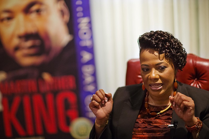 
              In this Friday, Jan. 8, 2016 photo, Bernice King, daughter of Martin Luther King Jr., speaks during an interview in front of an image of her father at the King Center in Atlanta. Marking the 30th anniversary of the Martin Luther King Jr. holiday, the King Center is focusing on the civil rights icon's call for freedom, his daughter Bernice King said. (AP Photo/David Goldman)
            