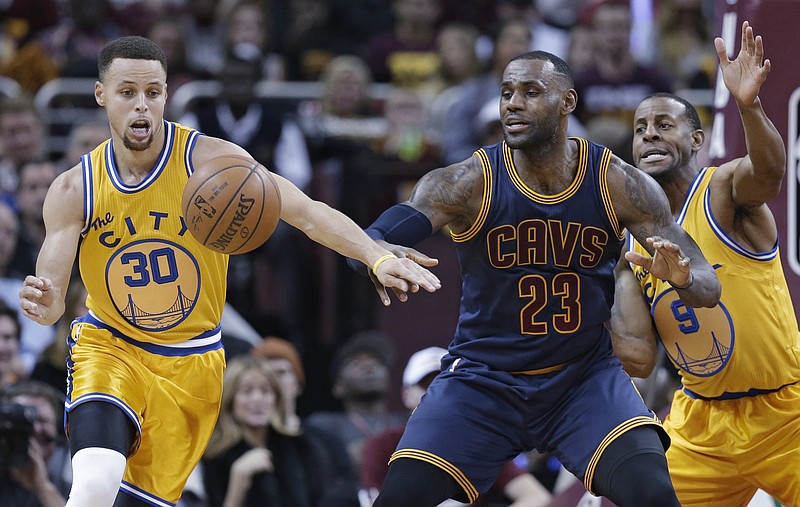 
              Golden State Warriors’ Stephen Curry (30) knocks the ball loose from Cleveland Cavaliers' LeBron James (23) in the first half of an NBA basketball game, Monday, Jan. 18, 2016, in Cleveland. Andre Iguodala (9) is at right. (AP Photo/Tony Dejak)
            