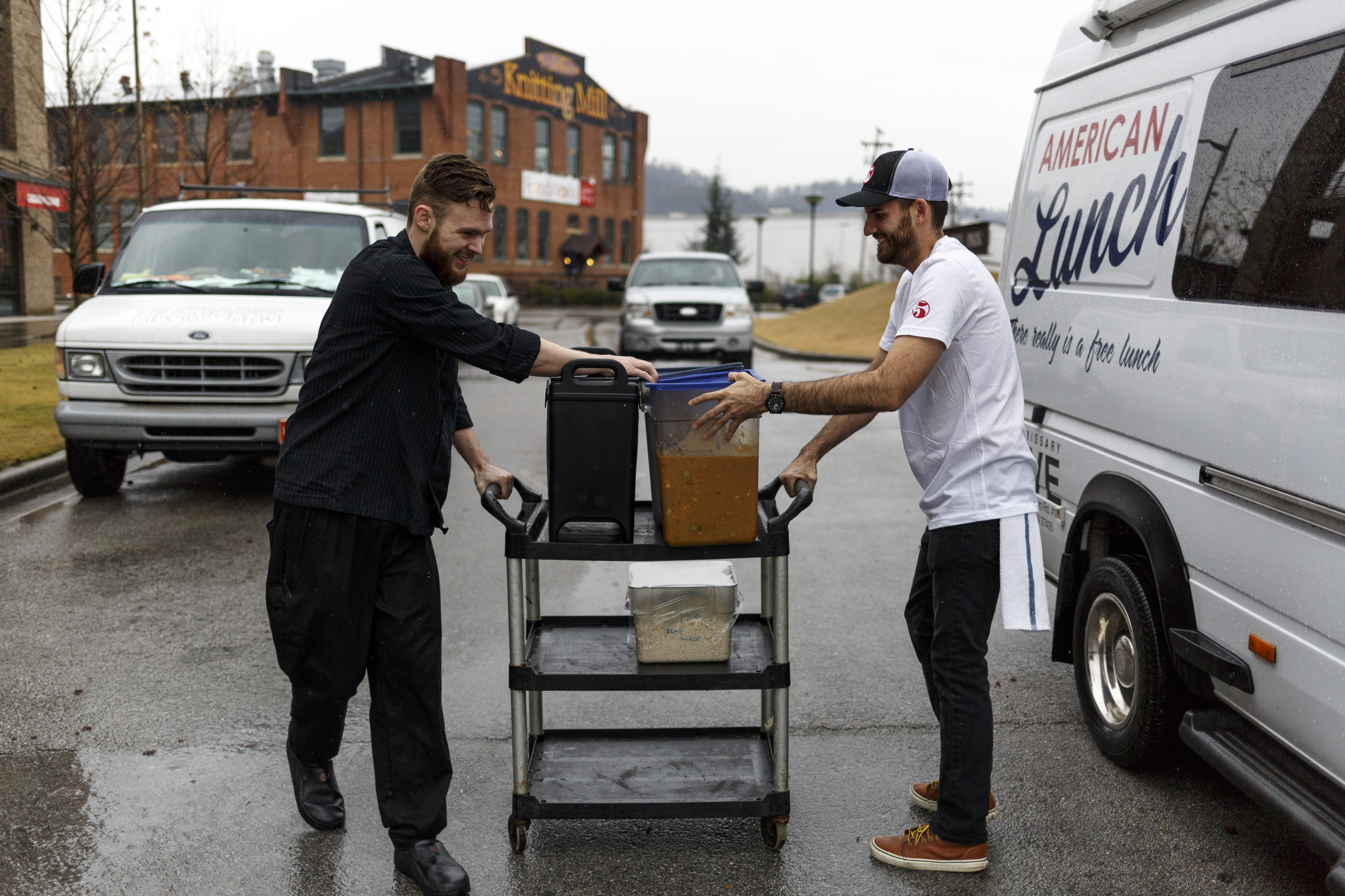 Head chef Jared Little, left, and Nate Brown load up the food truck outside of Five Bar. Beginning last September, the restaurant began serving free lunches at the Boynton Terrace apartments out of the food truck on Mondays, Wednesdays, and Fridays.