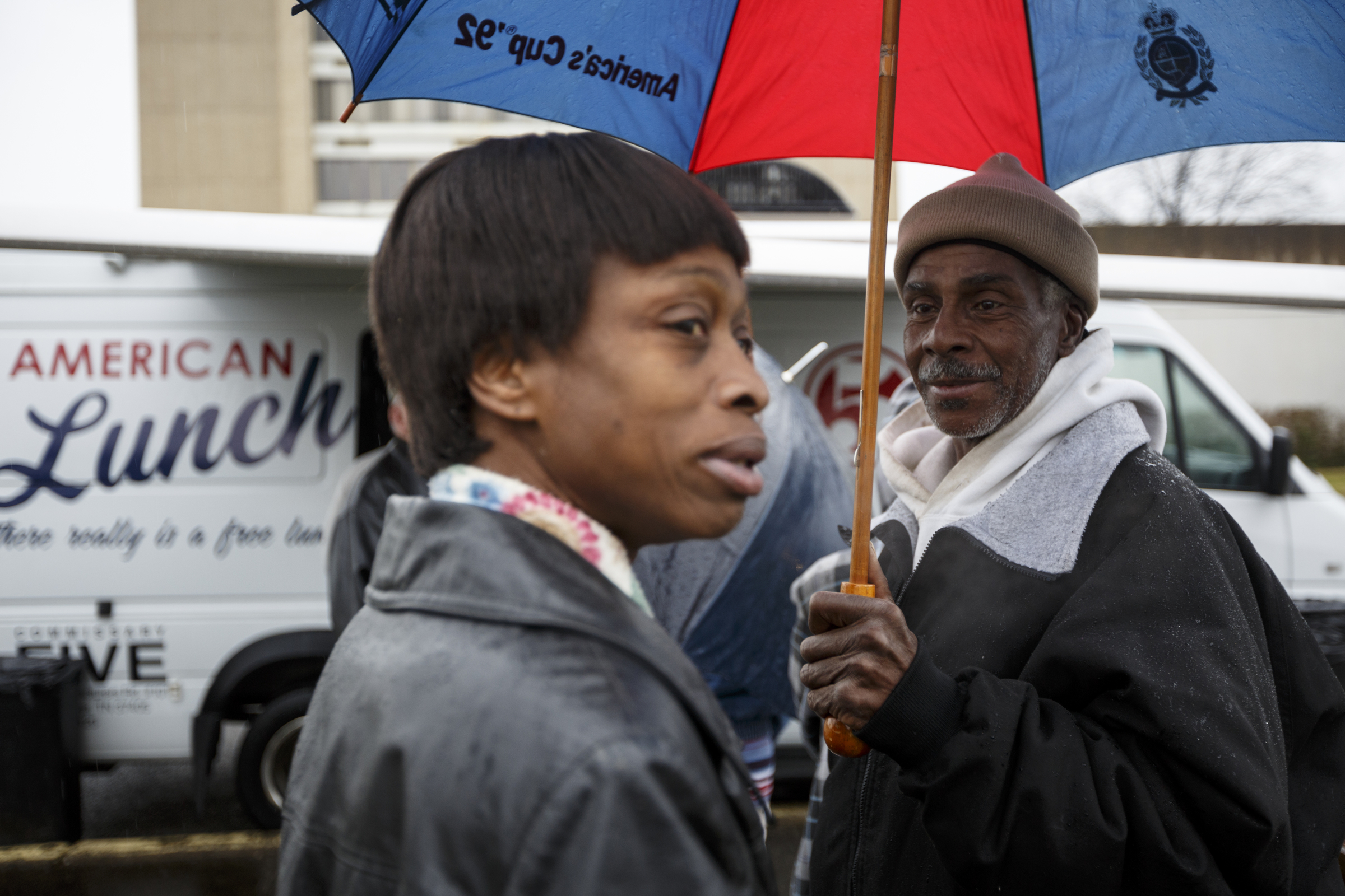 Joyce Gay, left, and Robert Stodmire wait in line outside of the food truck near the Boynton Terrace Apartments.