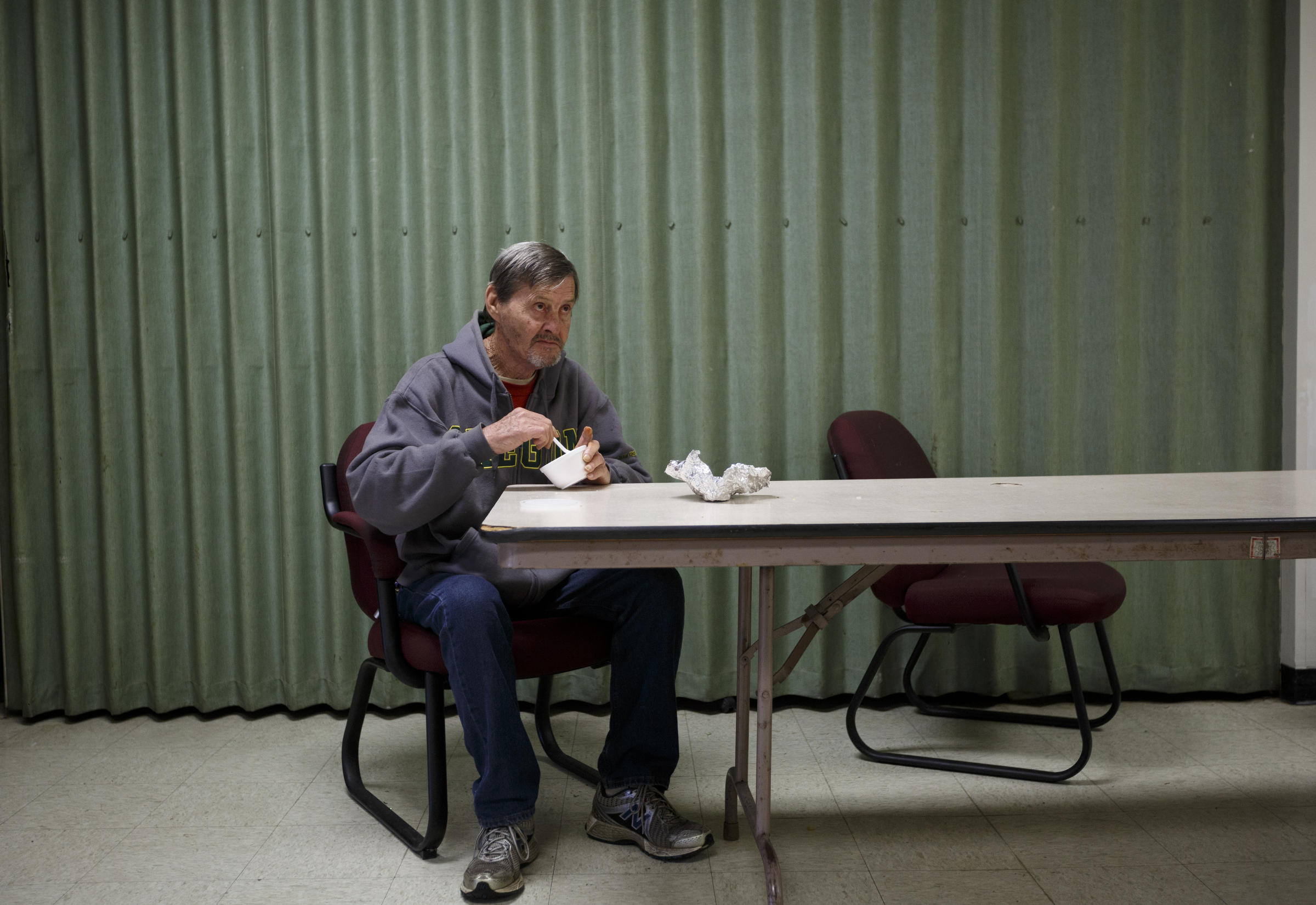 Billy Johnson, who has lived in Boynton Terrace for 12 years, eats gumbo in the common area.