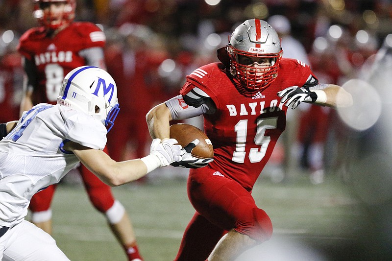 Staff Photo by Dan Henry / The Chattanooga Times Free Press- 10/2/15. Baylor School's Ryan Parker (15) runs the ball past McCallie School's Garrett Lunn (11) to score a touchdown during the first half of play at the Red Raider's home field on October 2, 2015. 