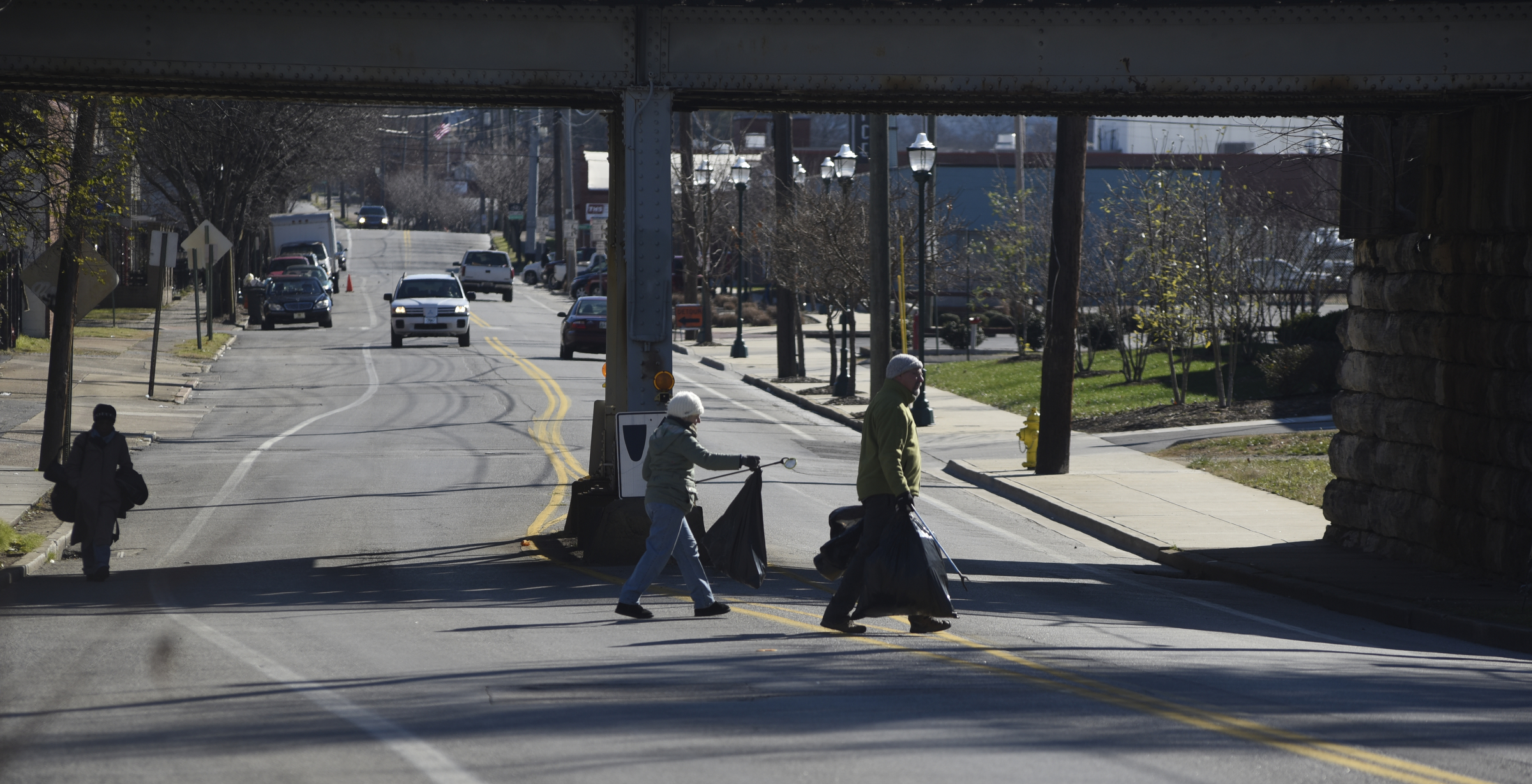 Chuck Jones, right, and Diane McCluskey cross 11th Street picking up trash as they and other volunteers participate in a day of service on Monday, Jan. 18, 2016, in Chattanooga, Tenn.