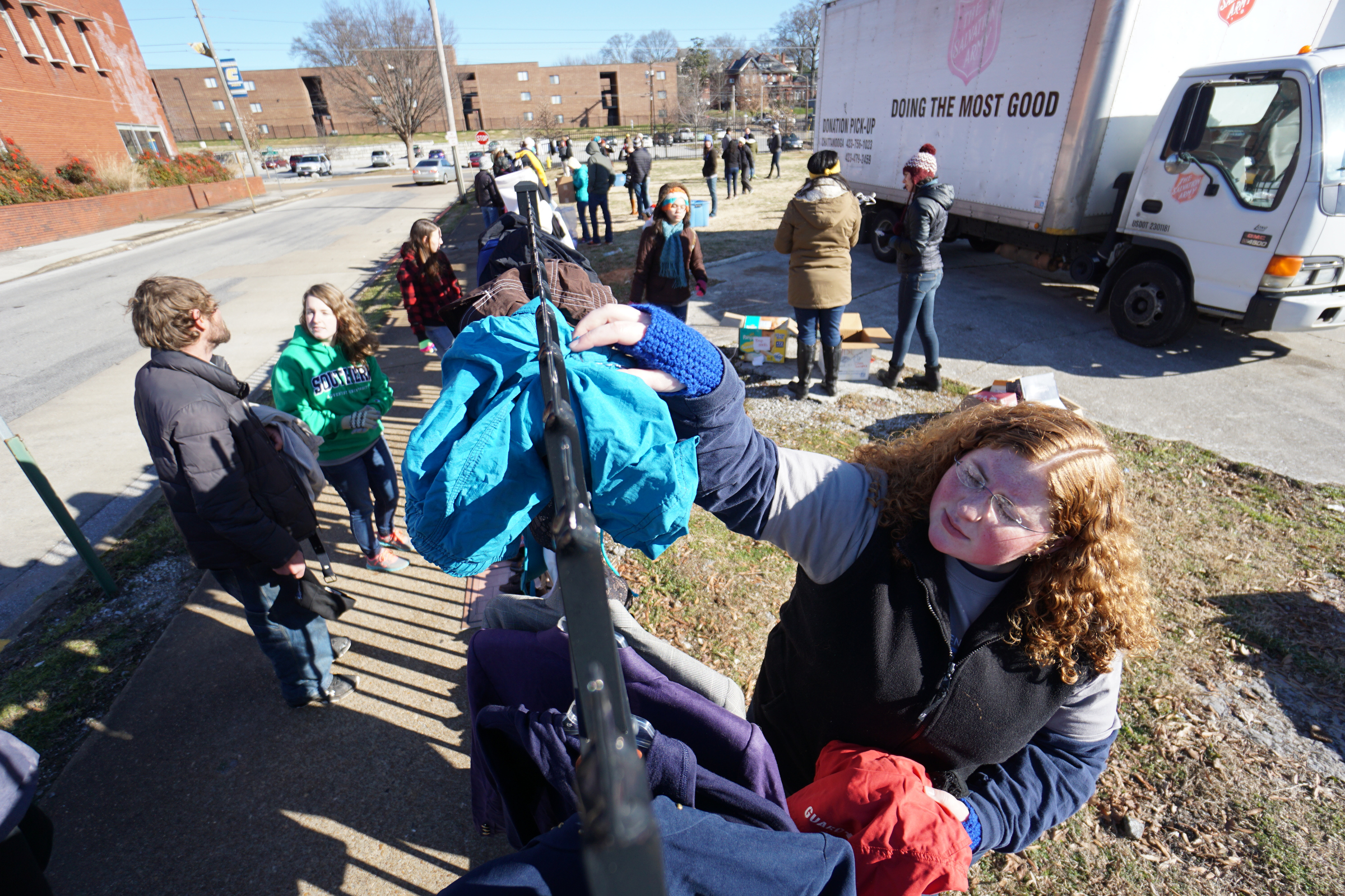 Staff Photo by Dan Henry / The Chattanooga Times Free Press- 1/18/16. Southern Adventist University junior classman Loubeth Vaughn, right, restocks the fence as SAU hosts the second annual ғtreet StoreӠin partnership with the Salvation Army on January 18, 2016. Street Stores are sidewalk pop-up shops that offers free clothes to the homeless, providing them with a dignified shopping experience as they try on and select their own garments. More than 4,000 individuals experience homelessness each year in Chattanooga alone.