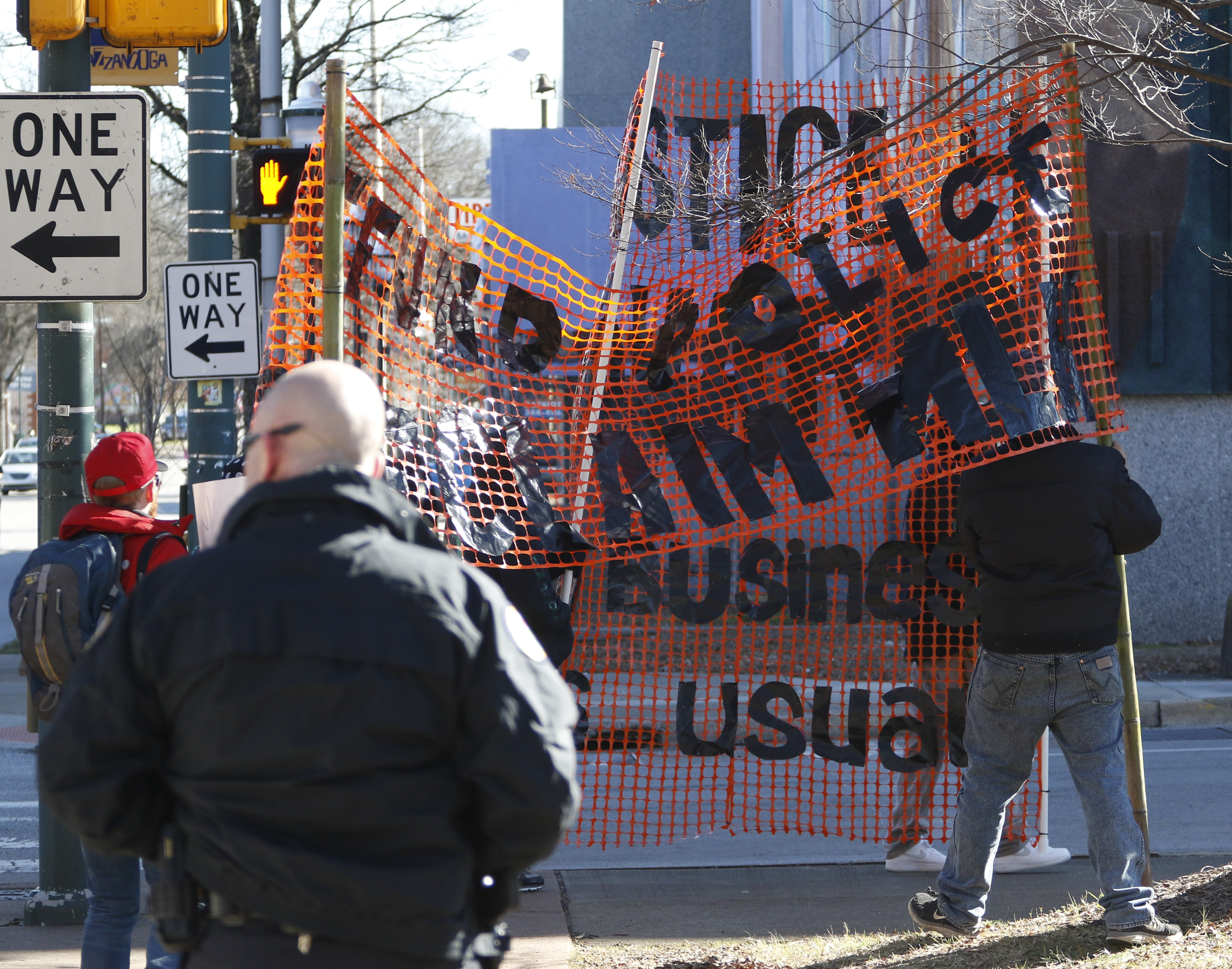 Staff Photo by Dan Henry / The Chattanooga Times Free Press- 1/18/16. Protesters circle a crowd during the $200,000 M.L. King Blvd. mural project dedication on January 18, 2016.