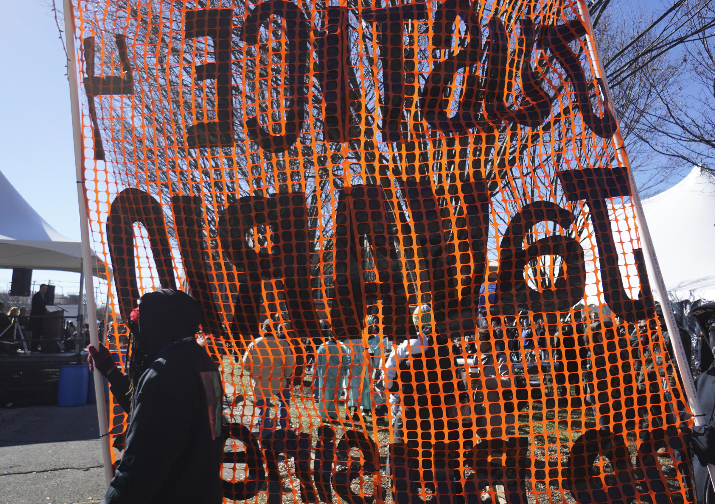 Staff Photo by Dan Henry / The Chattanooga Times Free Press- 1/18/16. Protesters circle a crowd during the $200,000 M.L. King Blvd. mural project dedication on January 18, 2016.