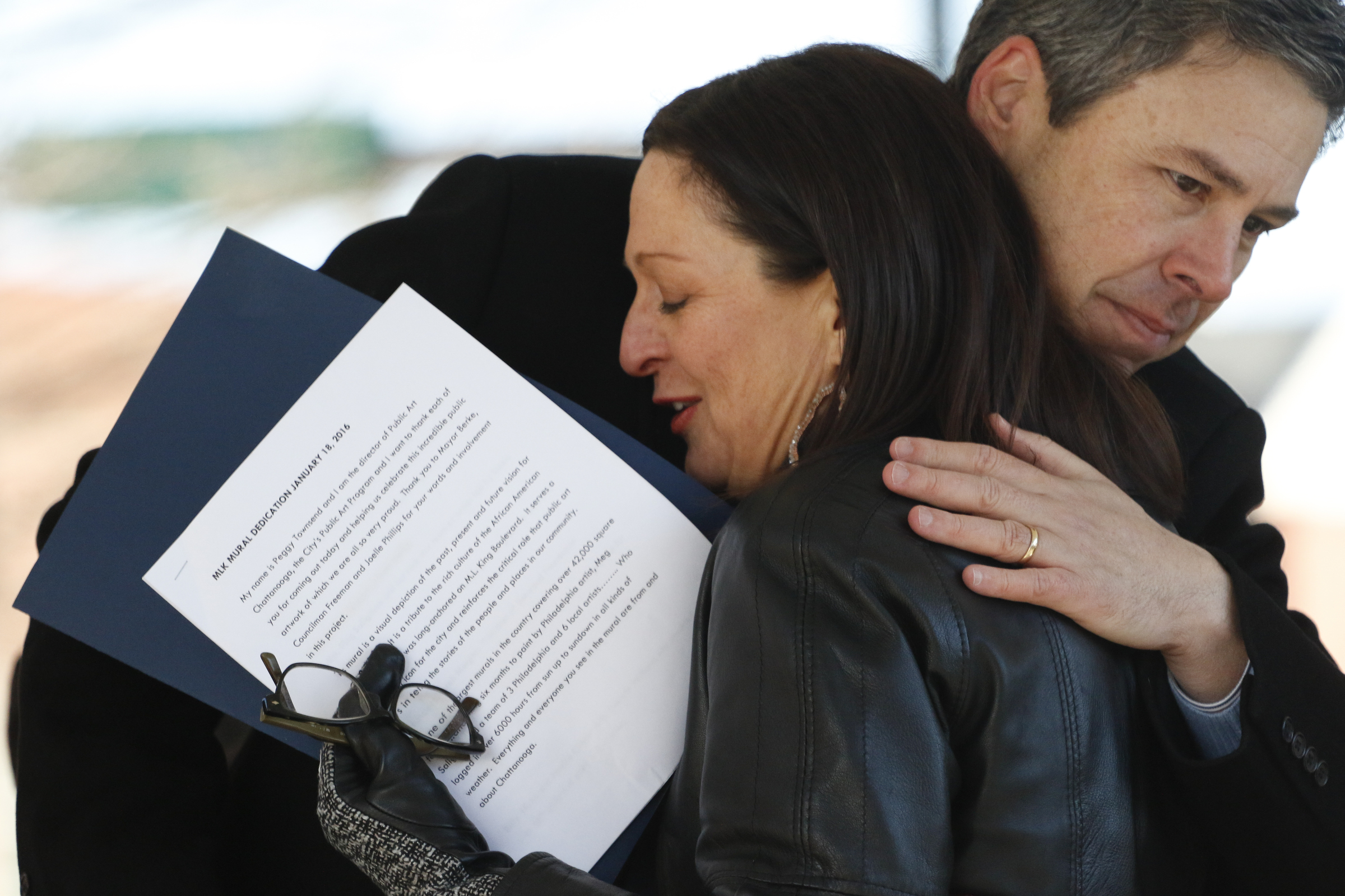 Staff Photo by Dan Henry / The Chattanooga Times Free Press- 1/18/16. Chattanooga City Mayor Andy Berke hugs Peggy Townsend during the dedication of the $200,000 M.L. King Blvd. mural project on January 18, 2016.