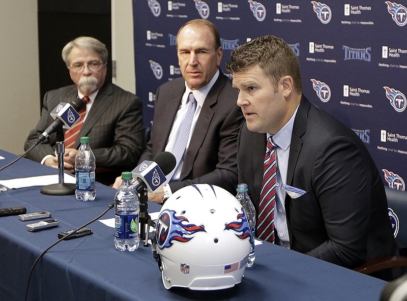Recently hired Tennessee Titans general manager Jon Robinson, right, answers questions at a news conference with head coach Mike Mularkey, center, Monday, Jan. 18, 2016, in Nashville, Tenn. Mularkey was previously the team's interim head coach and Robinson was the director of player personnel for the Tampa Bay Buccaneers. At left is Steve Underwood, president and CEO. (AP Photo/Mark Humphrey)
