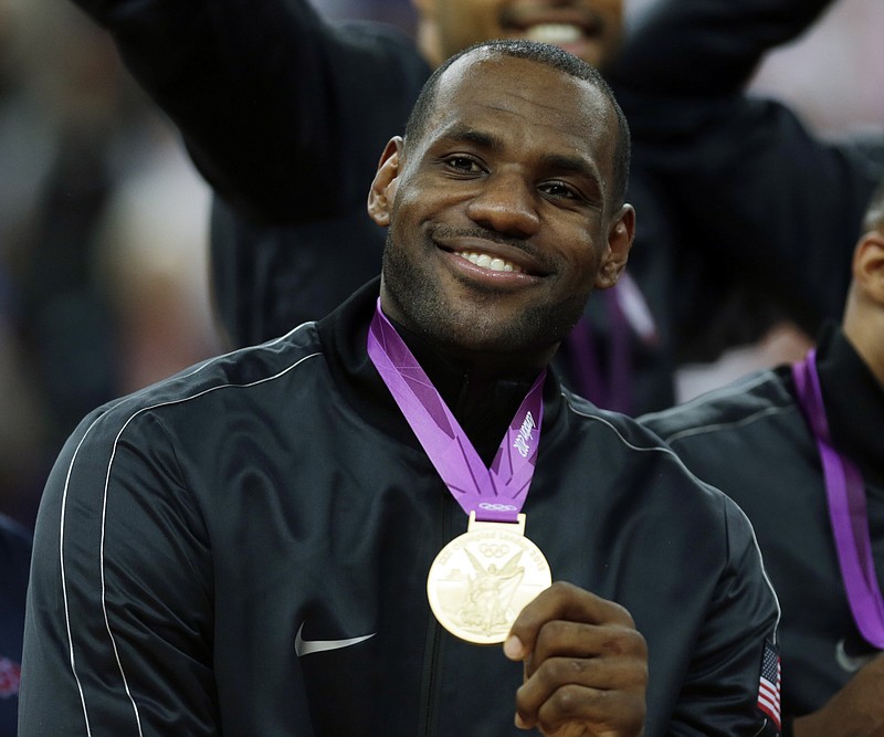 
              FILE - In this Aug. 12, 2012, file photo, United States' LeBron James celebrates after winning the gold medal at the men's basketball game against Spain at the 2012 Summer Olympics, in London. LeBron James and Carmelo Anthony are a step closer to a fourth Olympics, and Stephen Curry is in position for his first. The NBA stars were among 30 players selected Monday, Jan. 18, 2016, as finalists for the U.S. basketball team that will attempt in Rio de Janeiro to win a third straight gold medal. (AP Photo/Charles Krupa, File)
            