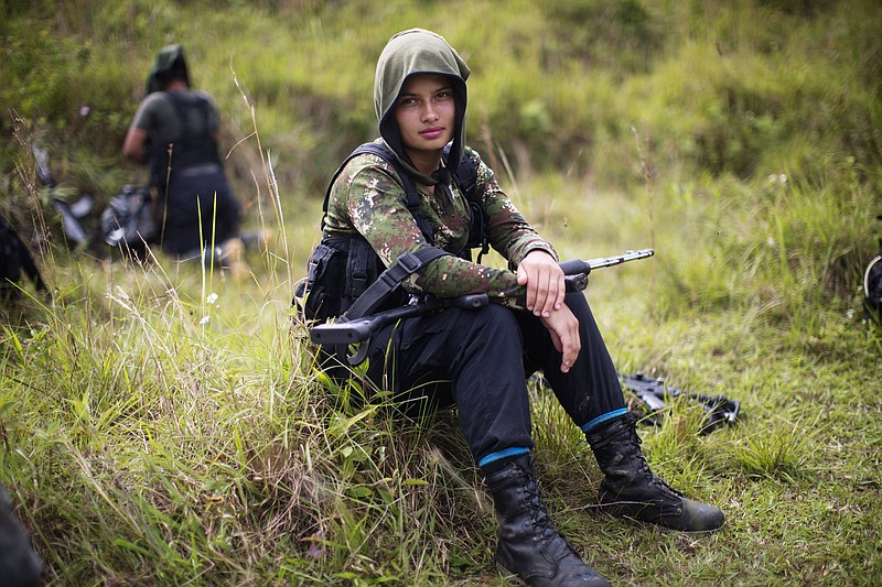 
              In this Jan. 6, 2016 photo, Juliana, a 20-year-old rebel fighter for the 36th Front of the Revolutionary Armed Forces of Colombia, or FARC, rests from a trek in the northwest Andes of Colombia, in Antioquia state. Like many of her comrades in arms, her path to the FARC was born as much from personal tragedy as political ideology. In her case, she fled an impoverished home at age 16 and followed in the footsteps of an uncle after being raped by her stepfather. (AP Photo/Rodrigo Abd)
            