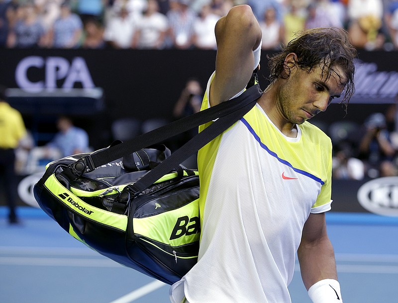 Rafael Nadal of Spain packs his bags to leave Rod Laver Arena following his loss to compatriot Fernando Verdasco in their first-round match Tuesday at the Australian Open tennis tournament in Melbourne.