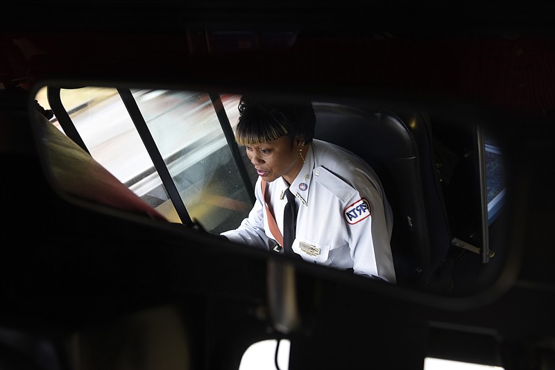 Seen reflected in a mirror, Norma Sanders operates her CARTA bus on the St. Elmo route on Wednesday, Jan. 20, 2016, in Chattanooga, Tenn. She is being honored for becoming CARTA's first female driver to join the Million Mile Club, an award earned by drivers with over one million miles without a chargeable accident. In 2014, she became the first female to be CARTA's most senior driver. 