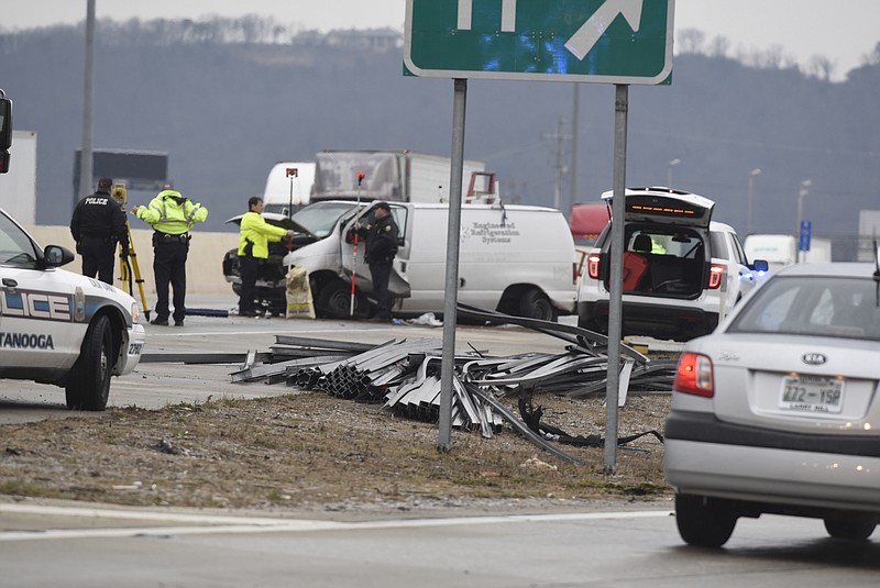 A load of large metal pieces are scattered across the roadway on I-75 blocking traffic in both directions on the icy overpass at the Ooltewah exit on Wednesday, Jan. 20, 2016, in Chattanooga, Tenn. due to an accident. 