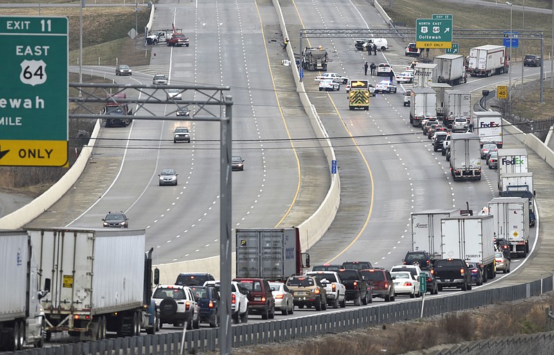 Traffic is diverted from I-75 in both directions due to accidents on the icy overpass at the Ooltewah exit on Wednesday, Jan. 20, 2016, in Chattanooga, Tenn. A load of large metal pieces were scattered across the roadway due to the accident. 
