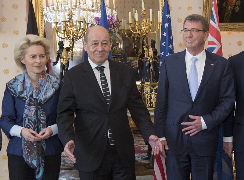 
              French Defense Minister Jean-Yves Le Drian, center, gestures next to German Defense Minister Ursula von der Leyen, left, and U.S. Defense Secretary Ash Carter after posing for a picture during a meeting at the Defense Ministry in Paris, Wednesday, Jan. 20, 2016. Defense chiefs from seven countries meet in Paris to plan to intensify the fight against Islamic State group extremists. (AP Photo/Jacques Brinon)
            
