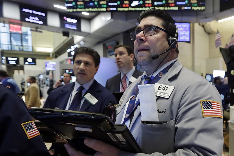Michael Capolino, right, works with fellow traders on the floor of the New York Stock Exchange, Wednesday, Jan. 20, 2016. Energy stocks are leading another sell-off on Wall Street as the price of oil continues to plunge. (AP Photo/Richard Drew)